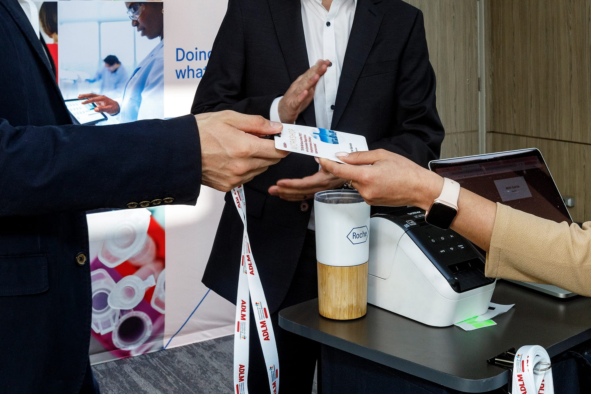 An attendee at the Roche-sponsored ADLM workshop receiving their badge. 