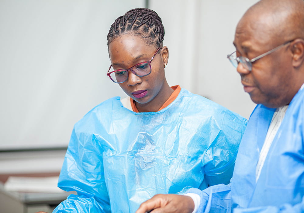 A man and woman in blue lab coats talking