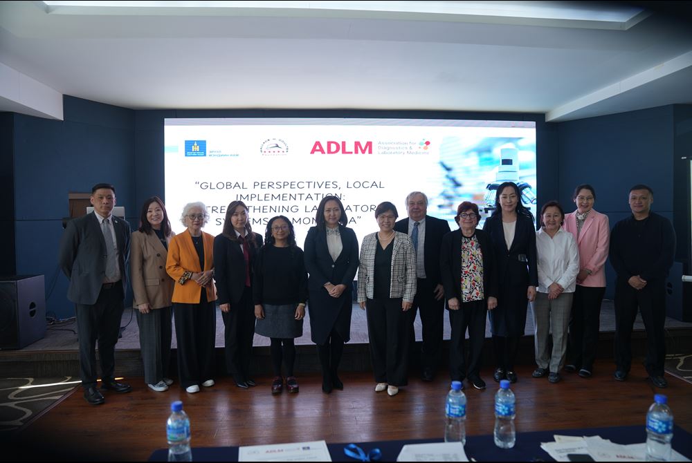 Attendees at the ADLM/MoH workshop with ADLM speakers posing in front of the screen.