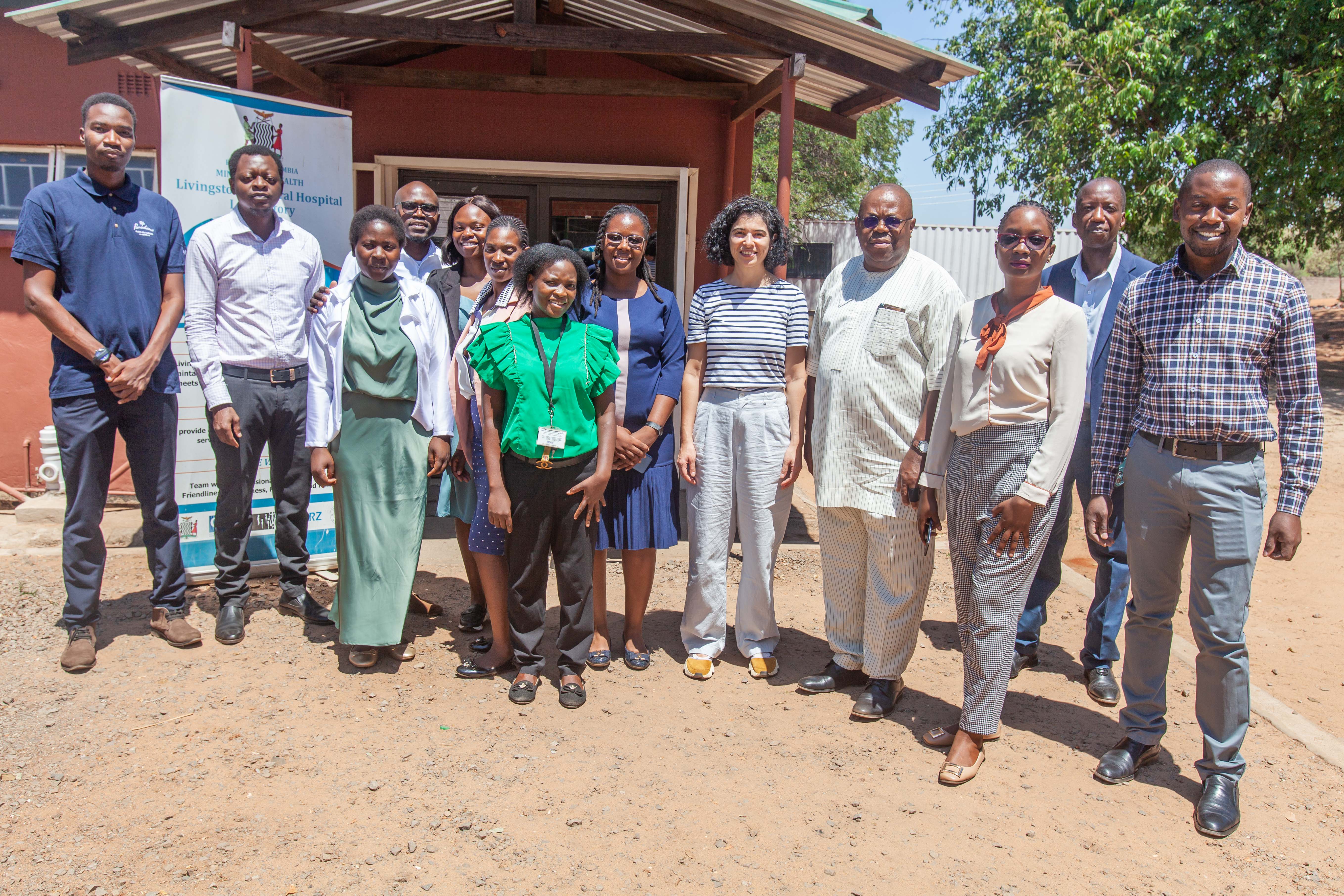 ADLM's Africa Working Group stands outside a building in Zambia.