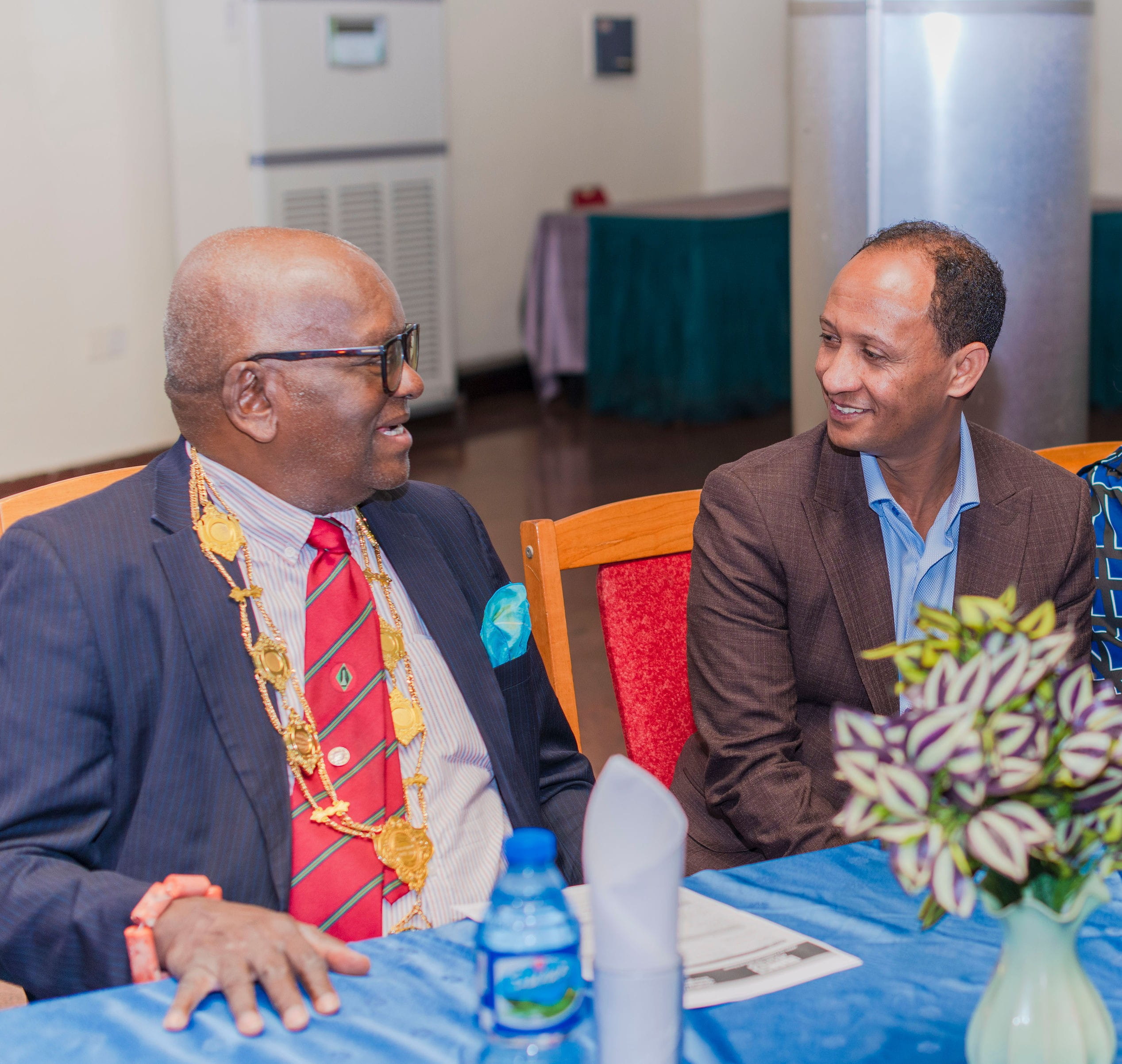 Merih Tesfazghi, chair of the Africa Subcommittee, speaking to Professor Osato Giwa Osagie, FAMedS, OON.