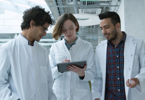 three laboratorians in a hallway