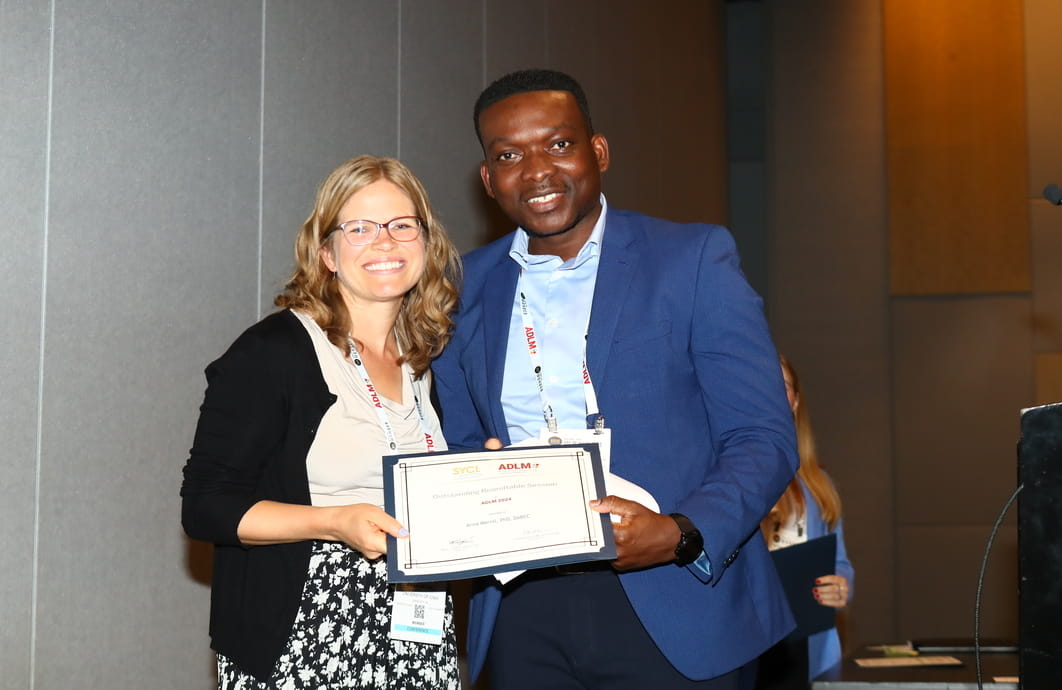 Two people holding an award