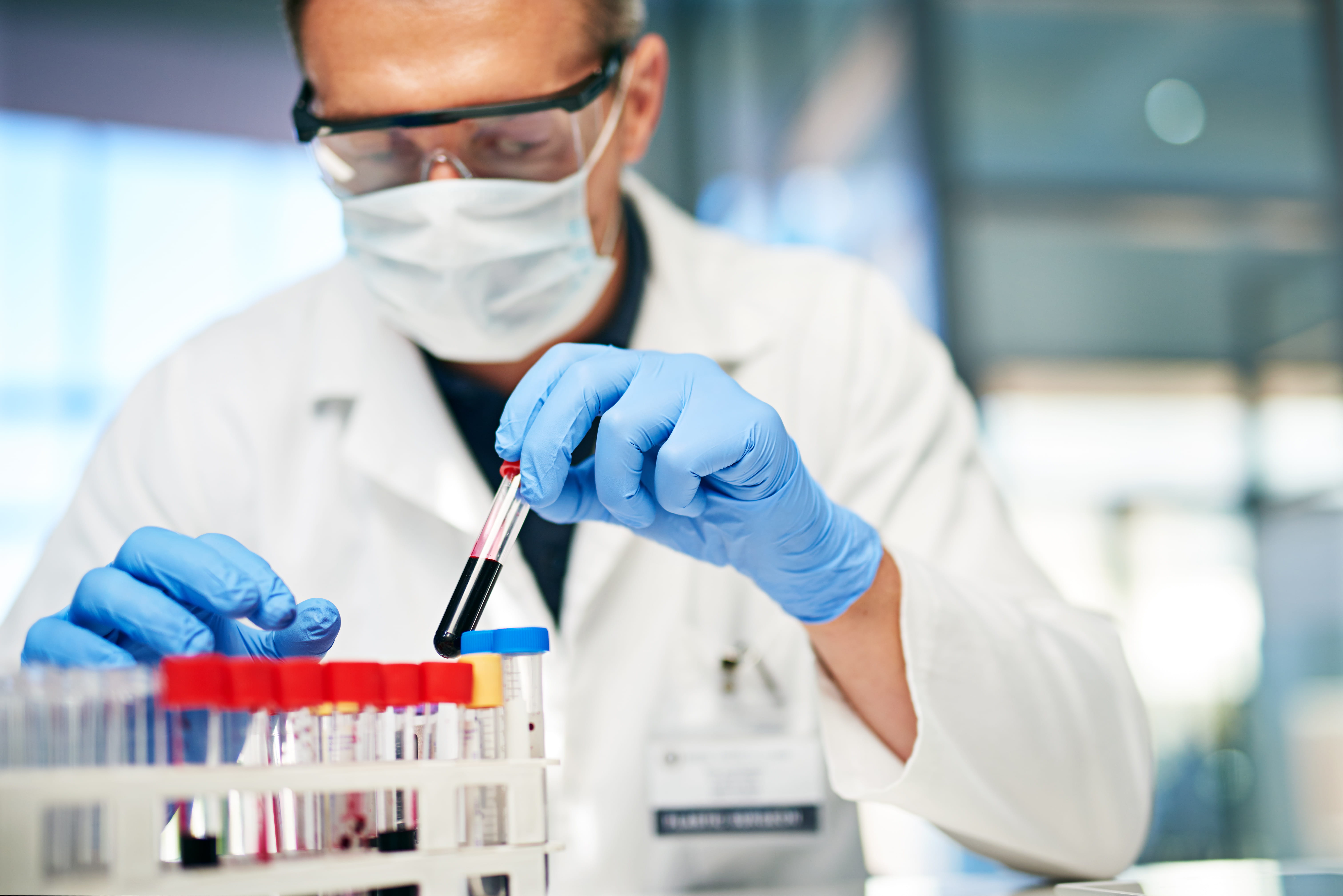 Male lab technician working with test tubes